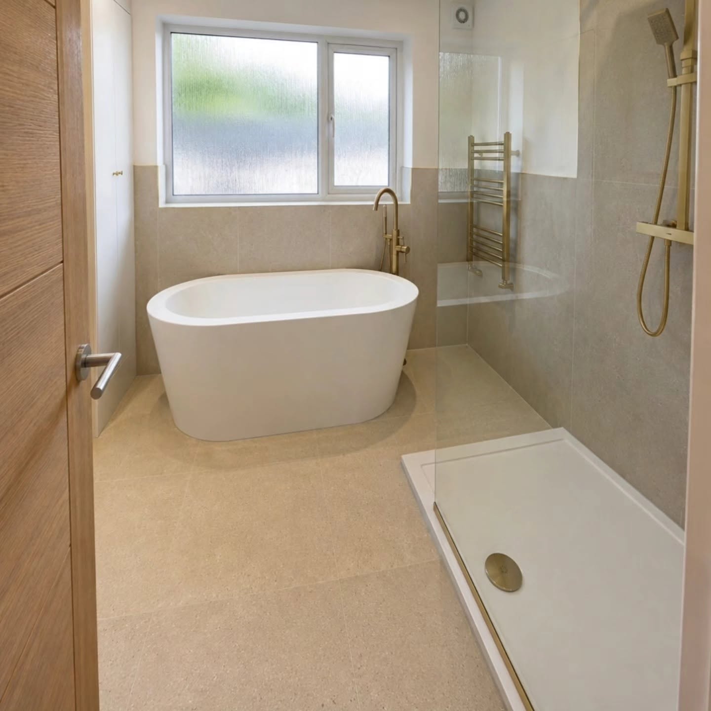 Transformed bathroom with freestanding bath, walk-in shower and 1200 x 600 stone tiles to the floor and walls
