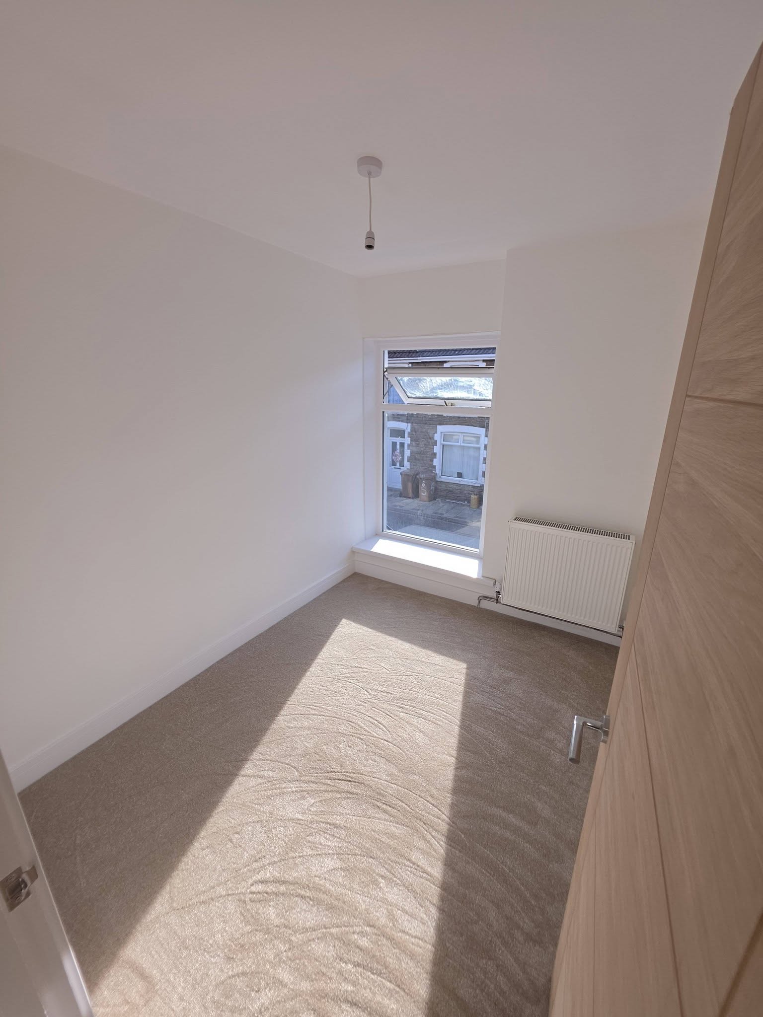 Bright bedroom with a replacement window, new radiator and fresh carpet