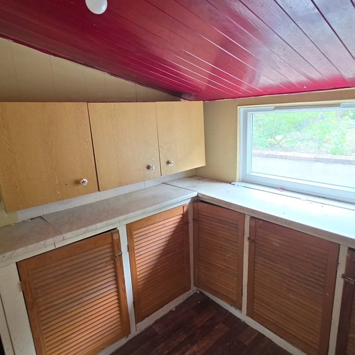 Before: back room with red panelled ceiling and old louvred cupboards