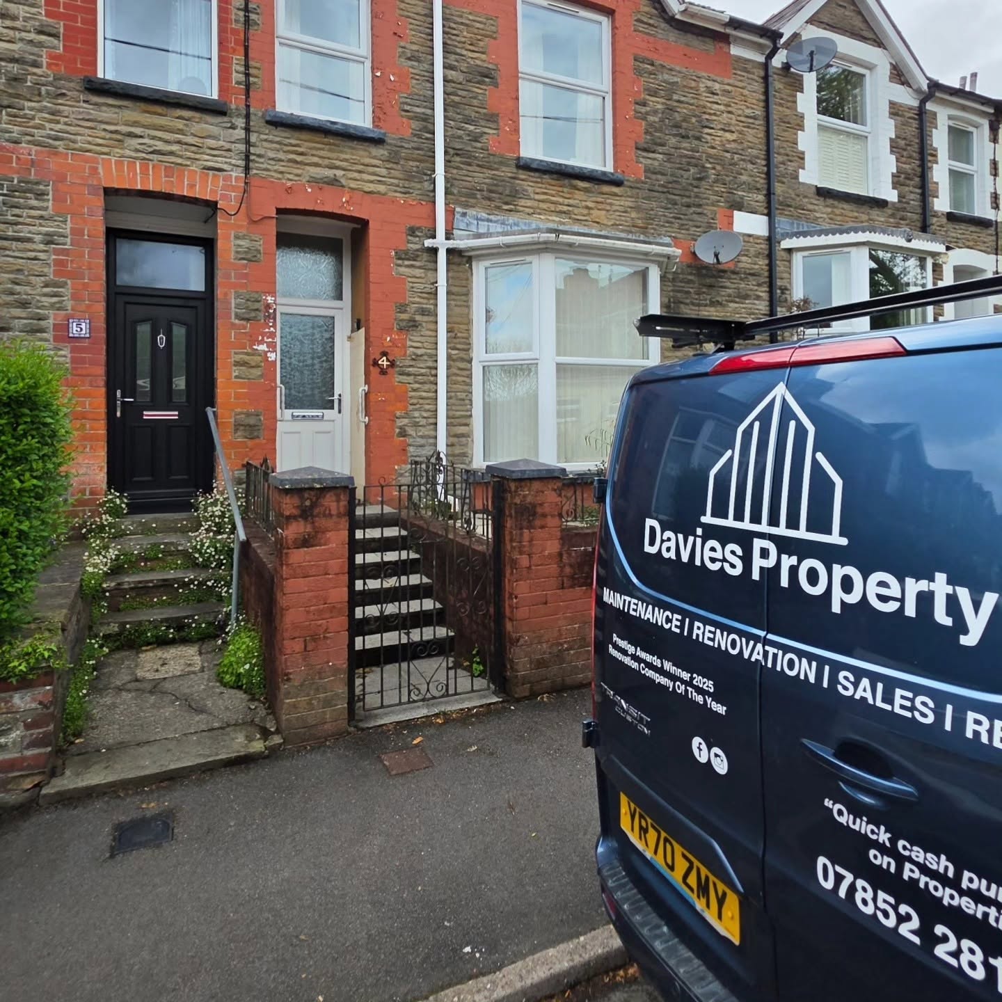 Front of the renovated Llanbradach terraced house with new black front door and the Davies Property van
