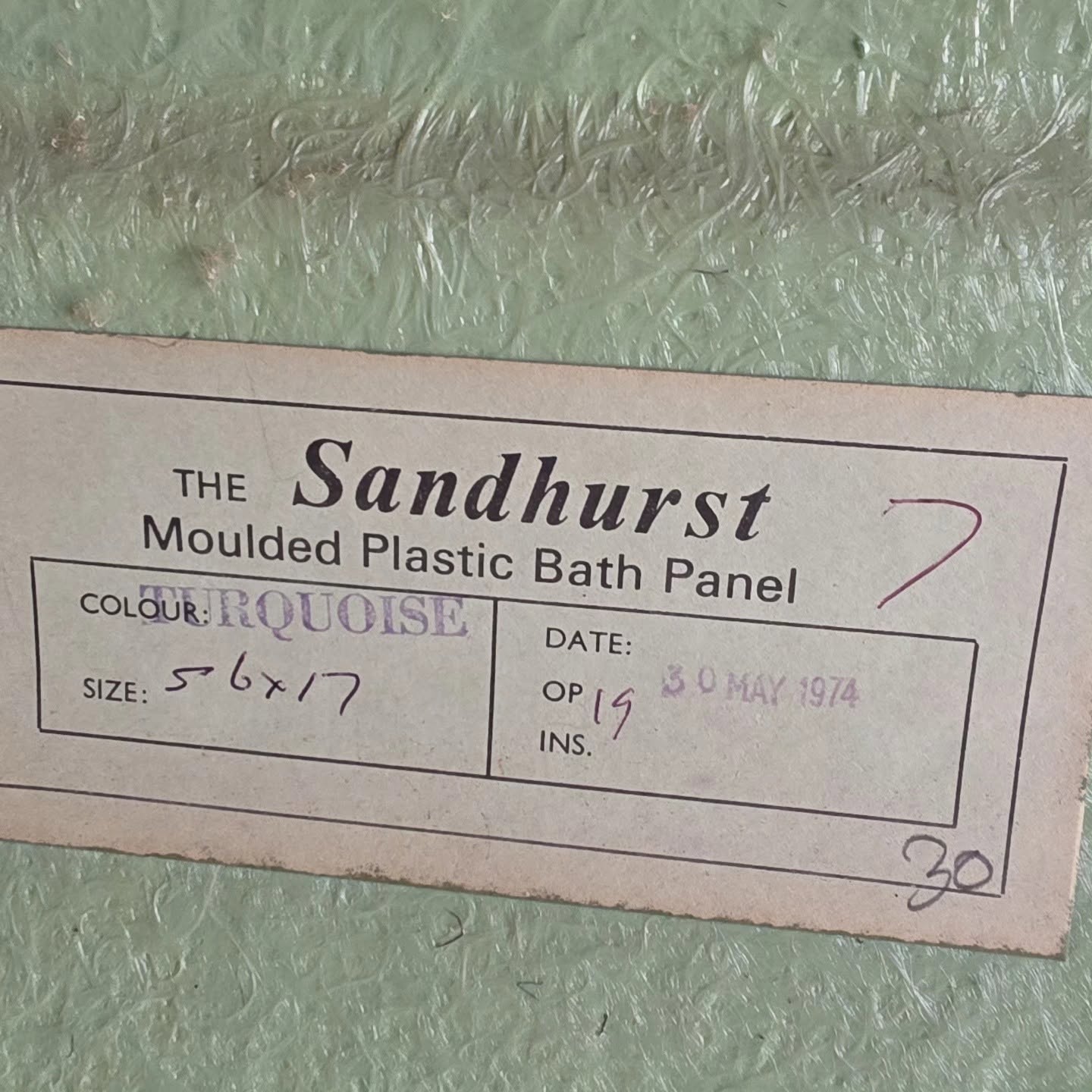 Before: original 1970s Sandhurst moulded plastic bath panel label found during the strip-out