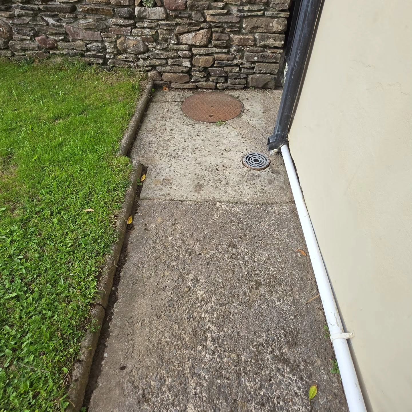 Before: old concrete path and manhole cover prior to the resin installation